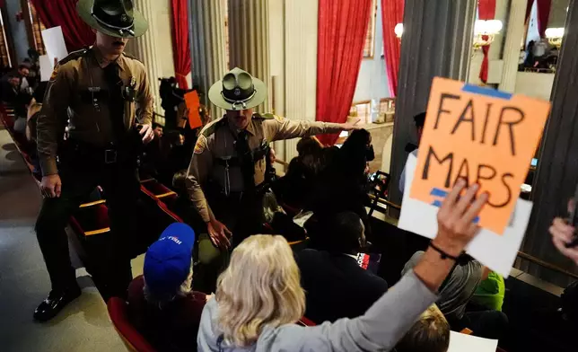 State troopers remove people from the House gallery during a special session of the state legislature to redraw U.S. Congressional voting maps Thursday, May 7, 2026, in Nashville, Tenn. (AP Photo/George Walker IV)