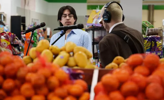 Luna Luna band members Kevin Gonzalez and Caleb Powers perform in the produce section of Fiesta Fresh Market in New Castle, Del., on Sunday, April 26, 2026. (AP Photo/Mingson Lau)