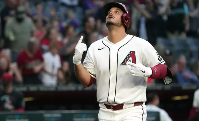 Arizona Diamondbacks' Nolan Arenado celebrates after hitting a grand slam against the San Francisco Giants in the first inning of a baseball game, Monday, May 18, 2026, in Phoenix. (AP Photo/Rick Scuteri)