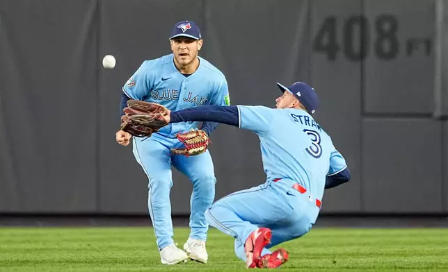 Toronto Blue Jays outfielders Myles Straw (3), catches a fly ball by New York Yankees J.C. Escarra during the third inning of a baseball game, Thursday, May 21, 2026. in New York. (AP Photo/Eduardo Munoz Alvarez)