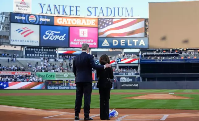 New York Yankees broadcasters Michael Kay, left, and Suzyn Waldman, right, stand during a tribute to late former Yankees broadcaster John Sterling ahead of a baseball game between the New York Yankees and the Baltimore Orioles, Monday, May 4, 2026, in New York. (AP Photo/Yuki Iwamura)