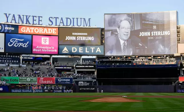 A scoreboard displays late former New York Yankees broadcaster John Sterling during a tribute to Sterling ahead of a baseball game between the New York Yankees and the Baltimore Orioles, Monday, May 4, 2026, in New York. (AP Photo/Yuki Iwamura)
