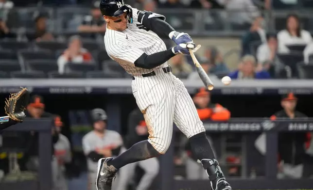 New York Yankees' Aaron Judge (99) hits an RBI single during the eighth inning of a baseball game against the Baltimore Orioles, Monday, May 4, 2026, in New York. (AP Photo/Yuki Iwamura)