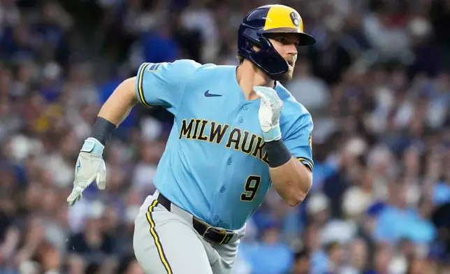 Milwaukee Brewers' Jake Bauers runs after hitting a one-run single during the third inning of a baseball game against the Chicago Cubs in Chicago, Tuesday, May 19, 2026. (AP Photo/Nam Y. Huh)
