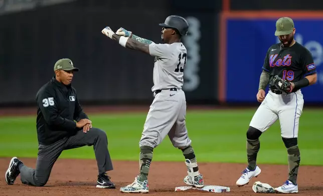 New York Yankees' Jazz Chisholm Jr., center, reacts after hitting an RBI double during the third inning of a baseball game against the New York Mets, Friday, May 15, 2026, in New York. (AP Photo/Yuki Iwamura)