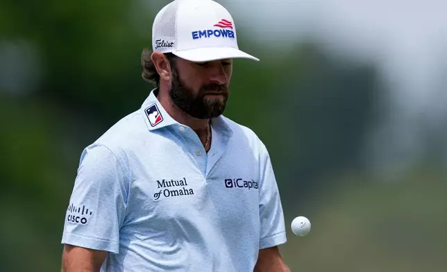 Cameron Young reacts tosses his ball on the fourth green during a PGA Championship golf tournament practice round at Aronimink Golf Club, Wednesday, May 13, 2026, in Newtown Square, PA. (AP Photo/Matt Slocum)
