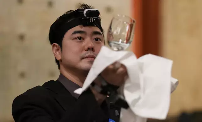 David Park, a food and beverages manager at Lotte Hotel Seoul, demonstrates during an interview with The Associated Press in Seoul, South Korea, Tuesday, April 28, 2026. (AP Photo/Lee Jin-man)