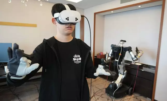Jeong Yong-hwa, robotics researcher/robotics pilot at RLWRLD, demonstrates during an interview with The Associated Press in Seoul, South Korea, Tuesday, April 28, 2026. (AP Photo/Lee Jin-man)