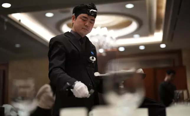 David Park, a food and beverages manager at Lotte Hotel Seoul, demonstrates during an interview with The Associated Press in Seoul, South Korea, Tuesday, April 28, 2026. (AP Photo/Lee Jin-man)