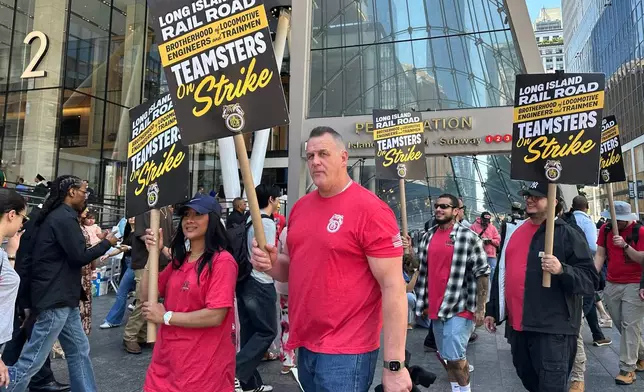 Long Island Rail Road workers, including locomotive engineer Karl Bischoff, center, picket outside Penn Station on the first day of a strike in New York, on Saturday, May 16, 2026. (AP Photo/Michael R. Sisak)