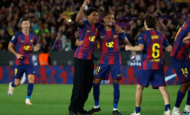 Barcelona's Lamine Yamal and Raphinha Barcelona celebrate after winning the Spanish La Liga soccer match between FC Barcelona and Real Madrid that makes them Spanish league champions in Barcelona, Spain, Sunday, May 10, 2026. (AP Photo/Joan Monfort)