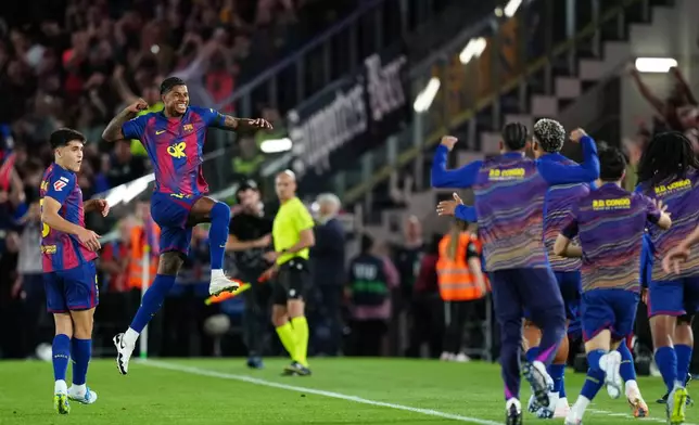 Barcelona's Marcus Rashford celebrates after scoring the opening goal during the Spanish La Liga soccer match between FC Barcelona and Real Madrid in Barcelona, Spain, Sunday, May 10, 2026. (AP Photo/Joan Mateu Parra)