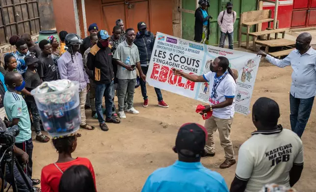 Francois Kasereka, a member of the Congo Scouts movement, speaks to people during a public sensitisation campaign amid the Ebola outbreak in Bunia, Congo, Saturday, May 23, 2026. (AP Photo/Moses Sawasawa)