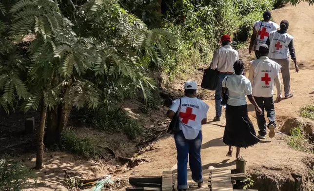 Red Cross volunteers on an outreach to speak to people during a public sensitisation campaign amid the Ebola outbreak in Bunia, Congo, Sunday, May 25, 2025. (AP Photo/Moses Sawasawa)