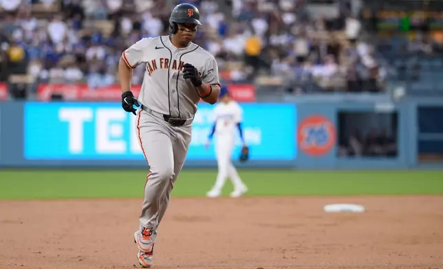 San Francisco Giants' Rafael Devers rounds the bases after hitting a solo home run during the second inning of a baseball game against the Los Angeles Dodgers in Los Angeles, Monday, May 11, 2026. (AP Photo/Kyusung Gong)