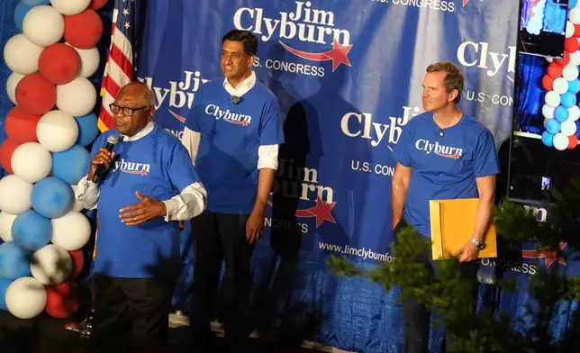 U.S. Rep. Jim Clyburn, D-S.C., left, speaks to attendees at his "World Famous Fish Fry" as U.S. Rep. Ro Khanna, D-Calif., and Democratic Gov. Andy Beshear of Kentucky look on, on Friday, May 29, 2026, in Columbia S.C. (AP Photo/Meg Kinnard)