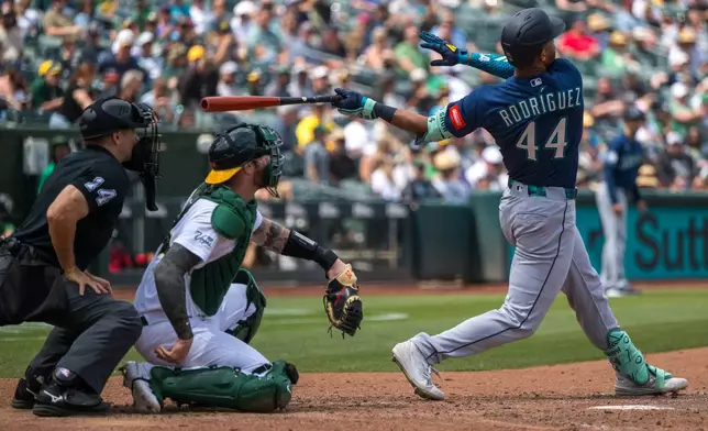 Seattle Mariners' Julio Rodríguez (44) hits a home run during the eighth inning of a baseball game against the Athletics in West Sacramento, Calif., Wednesday, May 27, 2026. (AP Photo/Nic Coury)