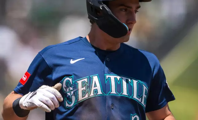 Seattle Mariners' Cole Young (2) scores during the fourth inning of a baseball game against the Athletics in West Sacramento, Calif., Wednesday, May 27, 2026. (AP Photo/Nic Coury)