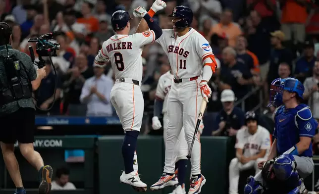 Houston Astros designated hitter Christian Walker (8) celebrates with Cam Smith after hitting a home run during the second inning of a baseball game against the Los Angeles Dodgers in Houston, Tuesday, May 5, 2026. (AP Photo/Ashley Landis)