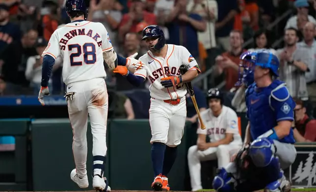 Houston Astros' Braden Shewmake (28) celebrates with Jose Altuve after hitting a home run during the third inning of a baseball game against the Los Angeles Dodgers in Houston, Tuesday, May 5, 2026. (AP Photo/Ashley Landis)