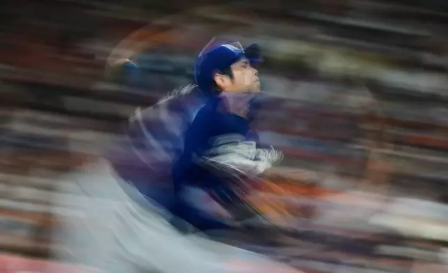 Los Angeles Dodgers starting pitcher Shohei Ohtani throws during the third inning of a baseball game against the Houston Astros in Houston, Tuesday, May 5, 2026. (AP Photo/Ashley Landis)