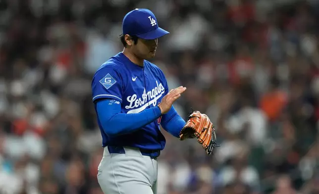 Los Angeles Dodgers starting pitcher Shohei Ohtani returns to the dugout after the top of the third inning of a baseball game against the Houston Astros in Houston, Tuesday, May 5, 2026. (AP Photo/Ashley Landis)