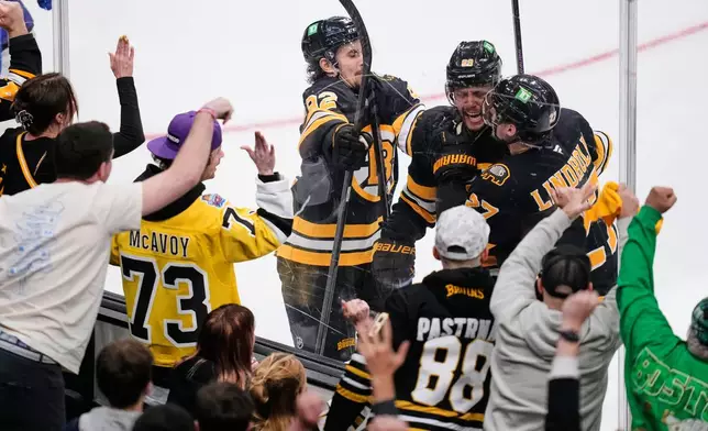 Boston Bruins right wing David Pastrnak, center, is congratulated after his goal during the second period in Game 6 of a first-round NHL hockey Stanley Cup playoff series against the Buffalo Sabres, Friday, May 1, 2026, in Boston. (AP Photo/Charles Krupa)