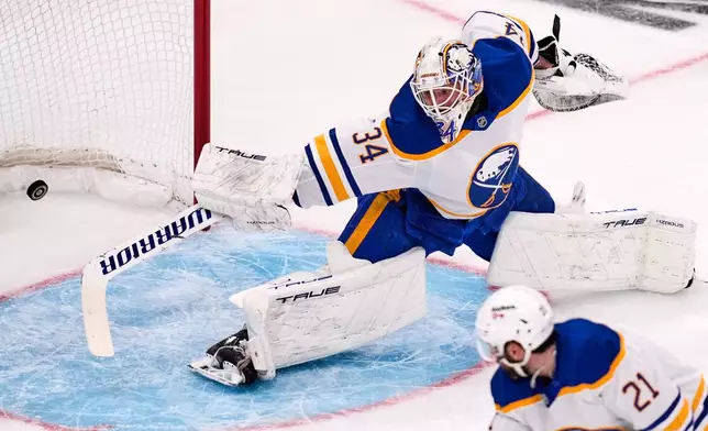 Buffalo Sabres goaltender Alex Lyon (34) stretches but cannot make a save on a goal by Boston Bruins right wing David Pastrnak (not shown) during the second period in Game 6 of a first-round NHL hockey Stanley Cup playoff series, Friday, May 1, 2026, in Boston. (AP Photo/Charles Krupa)
