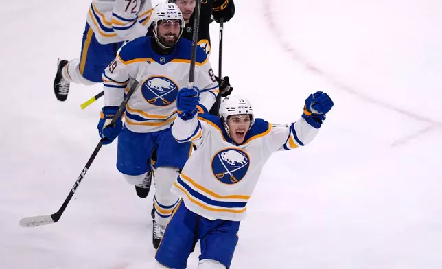 Buffalo Sabres center Peyton Krebs, front, celebrates after a goal by Mattias Samuelsson during the first period in Game 6 of a first-round NHL hockey Stanley Cup playoff series against the Boston Bruins, Friday, May 1, 2026, in Boston. (AP Photo/Charles Krupa)
