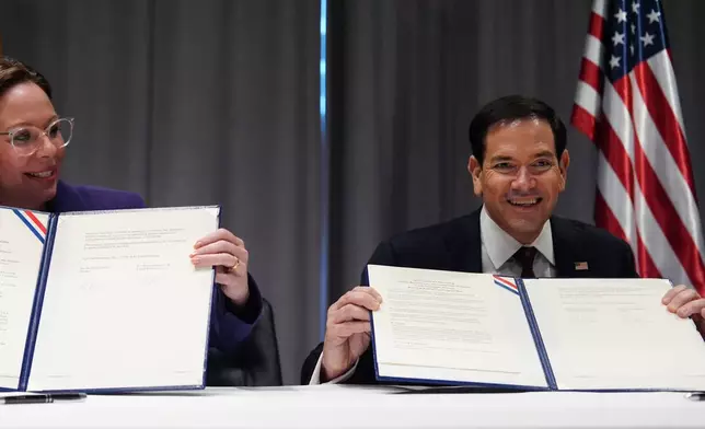 United States Secretary of State Marco Rubio, right, and Sweden's Foreign Minister Maria Malmer Stenergard hold up a memorandum of understanding during a signing ceremony on the sidelines of a meeting of NATO foreign ministers in Helsingborg, Sweden, Friday, May 22, 2026. (AP Photo/Julia Demaree Nikhinson, Pool)