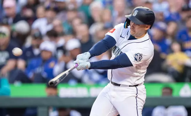 Seattle Mariners' Dominic Canzone hits a solo home run during the second inning of a baseball game against the Arizona Diamondbacks, Saturday, May 30, 2026, in Seattle. (AP Photo/Stephen Brashear)