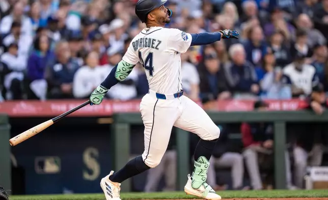 Seattle Mariners' Julio Rodriguez hits a solo home run during the third inning of a baseball game against the Arizona Diamondbacks, Saturday, May 30, 2026, in Seattle. (AP Photo/Stephen Brashear)