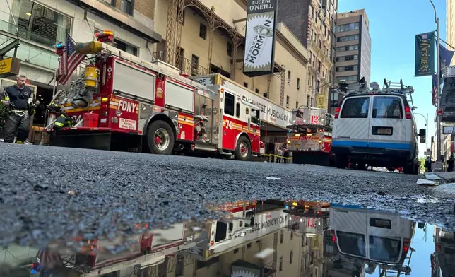 Firetrucks are parked outside of the Eugene O'Neill Theatre in New York on Monday, May 4, 2026. (AP Photo/David Martin)