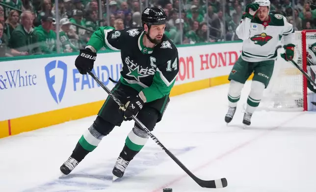 Dallas Stars left wing Jamie Benn skates with the puck against the Minnesota Wild during the first period in Game 5 of a first-round NHL Stanley Cup playoffs hockey series, Tuesday, April 28, 2026, in Dallas. (AP Photo/Julio Cortez)