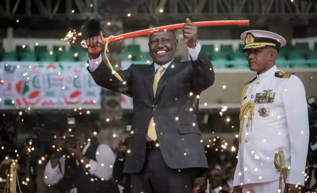 FILE - Kenya's new president William Ruto holds up a ceremonial sword as he is sworn in to office at a ceremony held at Kasarani stadium in Nairobi, Kenya Tuesday, Sept. 13, 2022. (AP Photo/Brian Inganga, File)