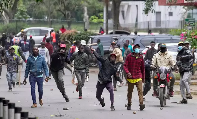 FILE - Pro-government supporters throw stones towards protesters during a demonstration over the death of blogger Albert Ojwang in police custody, in downtown Nairobi, Kenya, Tuesday, June 17, 2025. (AP Photo/Brian Inganga, File)