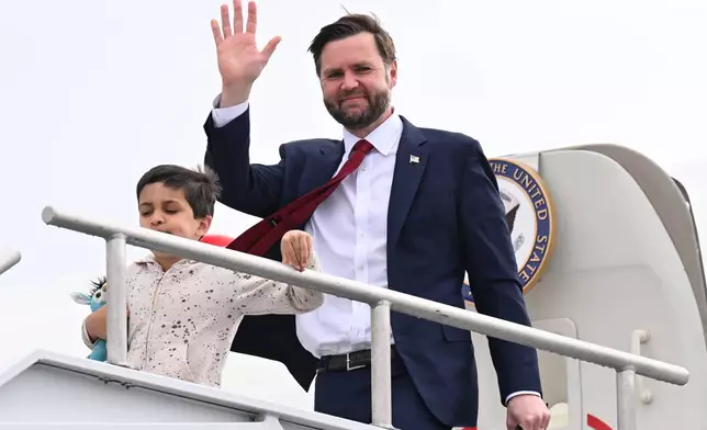 Vice President JD Vance and his son Vivek, walk off Air Force Two upon arrival at Cincinnati/Northern Kentucky International Airport in Hebron, Ky., Tuesday, May 5, 2026. Vance is stopping in Ohio to vote in the state's primary election before continuing on to Oklahoma and Iowa. (Roberto Schmidt /Pool Photo via AP)