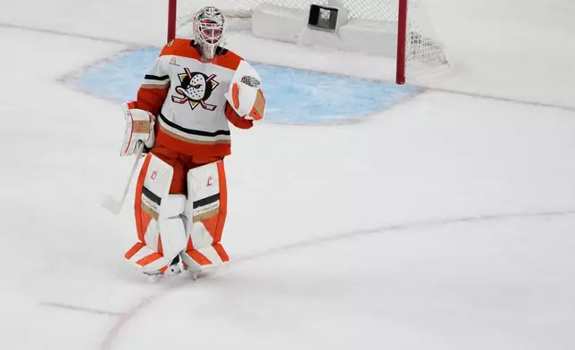 Anaheim Ducks goaltender Lukas Dostal (1) celebrates after the Anaheim Ducks defeated the Vegas Golden Knights in Game 2 of a second-round NHL hockey Stanley Cup playoff series Wednesday, May 6, 2026, in Las Vegas. (AP Photo/John Locher)