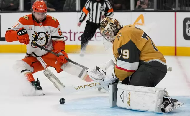 Vegas Golden Knights goaltender Carter Hart (79) stops a shot near Anaheim Ducks left wing Cutter Gauthier (61) during the first period of Game 2 of a second-round NHL hockey Stanley Cup playoff series Wednesday, May 6, 2026, in Las Vegas. (AP Photo/John Locher)