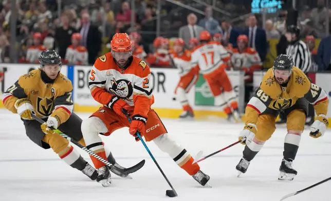 Anaheim Ducks center Ryan Poehling (25) skates against Vegas Golden Knights center William Karlsson (71) and Vegas Golden Knights center Tomas Hertl (48) during the first period of Game 2 of a second-round NHL hockey Stanley Cup playoff series Wednesday, May 6, 2026, in Las Vegas. (AP Photo/John Locher)