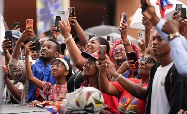 People react as players with Haiti's national soccer team walk onto the stage at a Haitian Heritage Month event, Saturday, May 30, 2026, in North Miami, Fla., ahead of the FIFA World Cup soccer tournament. (AP Photo/Lynne Sladky)