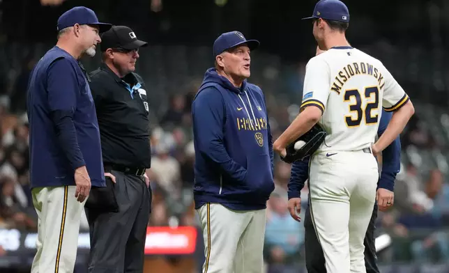 Milwaukee Brewers' Jacob Misiorowski talks, right, with Pat Murphy before the eighth inning of a baseball game against the San Diego Padres, Wednesday, May 13, 2026, in Milwaukee. (AP Photo/Aaron Gash)