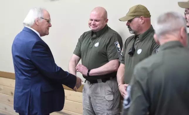 Mayor Ron Shinnick, left, shakes hands with members of the Cohutta Police Department at Cohutta Town Hall in Cohutta, Ga. on Thursday, April 30, 2026. (Matt Hamilton/Chattanooga Times Free Press via AP)