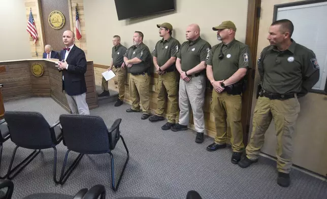 Mayor Ron Shinnick, back, and members of the Cohutta Police Department look on as lawyer Bryan Rayburn speaks at Cohutta Town Hall in Cohutta, Ga. on Thursday, April 30, 2026. (Matt Hamilton/Chattanooga Times Free Press via AP)