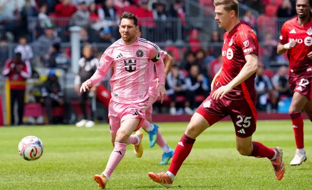 Inter Miami CF midfielder Lionel Messi (10) and Toronto FC defender Walker Zimmerman (25) chase the ball during first half MLS soccer in Toronto on Saturday, May 9, 2026. (Frank Gunn /The Canadian Press via AP)
