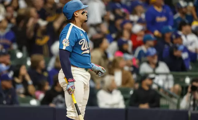 Milwaukee Brewers' William Contreras watches his three-run home run during the first inning of a baseball game against the Los Angeles Dodgers, Friday, May 22, 2026, in Milwaukee. (AP Photo/Jeffrey Phelps)
