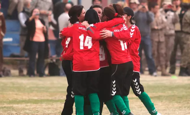 FILE - Members of the Afghan women's national soccer team celebrate their goal against the ISAF (International Security Assistance Force) female football team at the ISAF headquarters in Kabul, Afghanistan, Friday, Oct. 29, 2010. (AP Photo/Altaf Qadri, File)