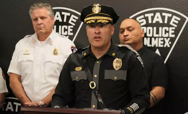 New Mexico State Police Chief Matt Broom, center, provides updates during a news conference in Albuquerque, New Mexico, on Friday, May 22, 2026 about an investigation into the deaths of three people in Torrance County and a potential fentanyl exposure for first responders who answered the call. The investigation is ongoing. (AP Photo/Susan Montoya Bryan)