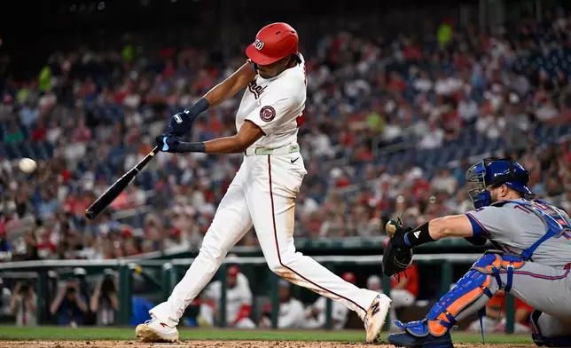 Washington Nationals' James Wood hits an inside the park grand slam home run during the second inning of a baseball game against the New York Mets, Tuesday, May 19, 2026, in Washington. (AP Photo/John McDonnell)