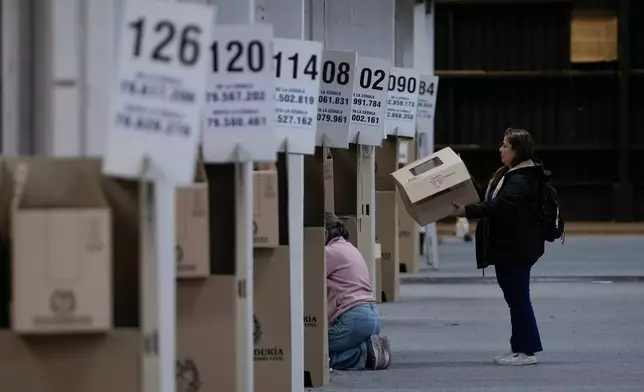 Electoral workers set up a voting center in preparation for Sunday's presidential election in Bogota, Colombia, Friday, May 29, 2026. (AP Photo/Matias Delacroix)